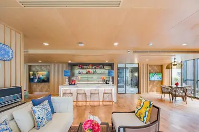 a living room with a white couch and a kitchen at The Base Central Phuket-C4YW in Phuket Town
