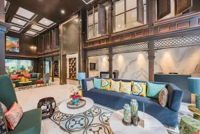 a living room with a blue couch and a table at The Base Central Phuket-C4YW in Phuket Town