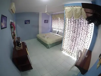 a living room with a bed and a window at Adams house in Patong Beach