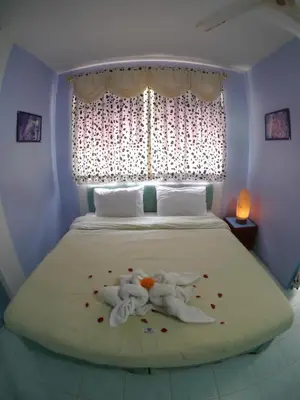 a bedroom with a bed with two stuffed animals on it at Adams house in Patong Beach