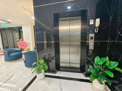 an elevator in a lobby with potted plants at The Answer Hotel in Ao Nang Beach