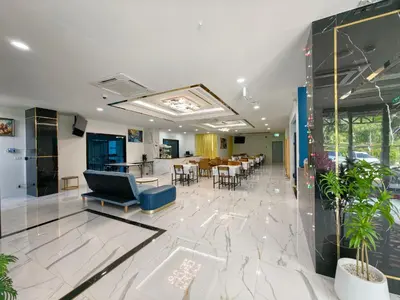 a lobby with a table and chairs in a building at The Answer Hotel in Ao Nang Beach