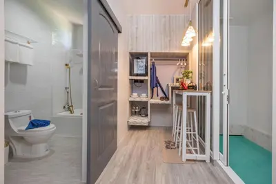 a small bathroom with a toilet and a sink at Best Time Pool Suites in Chalong
