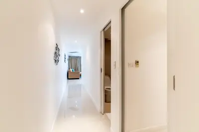 a hallway with white walls and a door to a bathroom at Apartment Kata Ocean View in Kata Beach