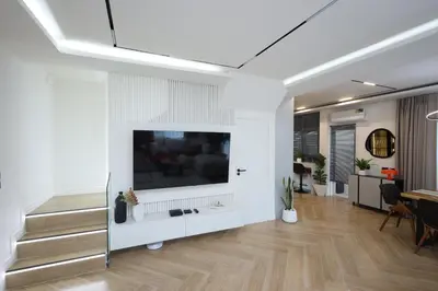 a living room with a large television on a wall at Phuket Paradise Retreat in Phuket Town