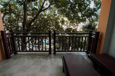 a balcony with a wooden fence and a tree at Rawai Palm Beach Квартира 220м in Rawai Beach