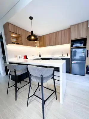 a kitchen with a table and chairs and a refrigerator at New apartment 2bedrooms in Laguna lakeside Bang Tao beach in Phuket