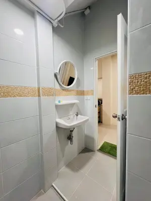 a bathroom with a sink and a mirror at Vista Residence Patong in Patong Beach