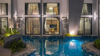 a swimming pool in the middle of a building at Duplex Condo pool access in Rawai Beach