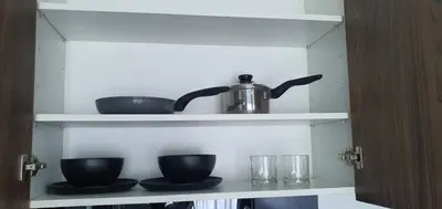 a shelf with cups and a tea pot on it at Duplex Condo pool access in Rawai Beach
