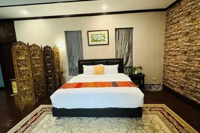 a bedroom with a large bed in a room at Vela House Phuket in Changwat Phuket