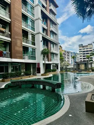 a swimming pool in front of a building at DREAMS APARTMENTS by ART PATONG RESIDENCE in Patong Beach