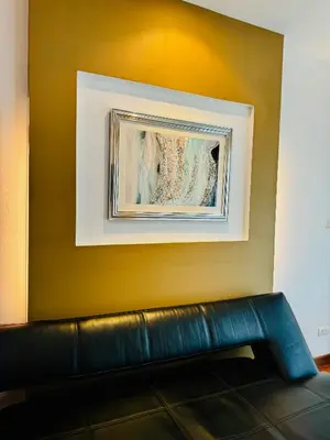 a couch in a room with a painting on a wall at DREAMS APARTMENTS by ART PATONG RESIDENCE in Patong Beach