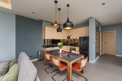 a kitchen and dining room with a table and chairs at Solano Tropical 3BR Pool Villa at Bang Tao in Layan Beach