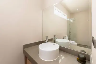 a white bathroom with a sink and a mirror at Solano Tropical 3BR Pool Villa at Bang Tao in Layan Beach
