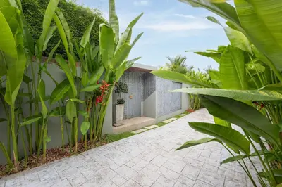 a courtyard of a house with green plants at Solano Tropical 3BR Pool Villa at Bang Tao in Layan Beach