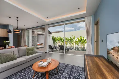 a living room with a couch and a table at Solano Tropical 3BR Pool Villa at Bang Tao in Layan Beach