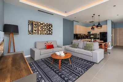a living room with two couches and a table at Solano Tropical 3BR Pool Villa at Bang Tao in Layan Beach
