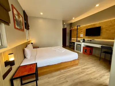 a hotel room with a bed and a television at Diva Boutique Hotel in Patong Beach