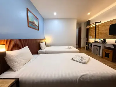 a hotel room with two beds and a bathroom at Diva Boutique Hotel in Patong Beach