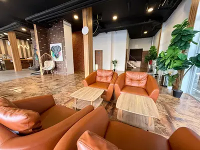 a lobby with leather couches and tables in a room at Diva Boutique Hotel in Patong Beach