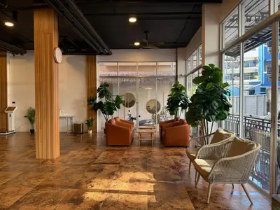 a lobby with chairs and tables and windows at Diva Boutique Hotel in Patong Beach