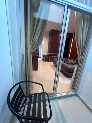 a black chair sitting in front of a window at NJoy Boutique Guesthouse in Patong Beach