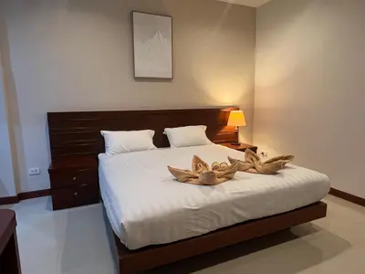a bedroom with a bed with two bowls on it at NJoy Boutique Guesthouse in Patong Beach