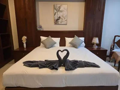 a bed with a heart made out of towels at NJoy Boutique Guesthouse in Patong Beach