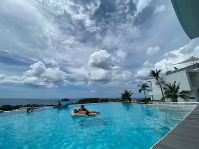 a group of people in a large swimming pool at Kata Beach TheView luxurious Condonomium in Kata Beach