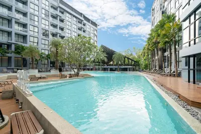 a swimming pool in the middle of a building at Citygate Kamala Resort in Kamala Beach