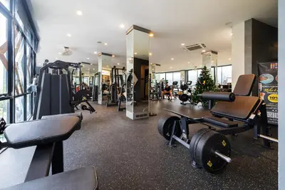 a gym with tread machines and a christmas tree at Citygate Kamala Resort in Kamala Beach