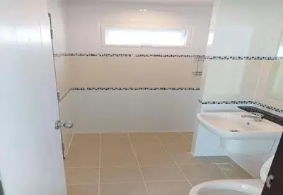 a bathroom with a sink and a toilet at Cozy House by Cody One in Thalang