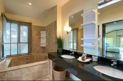 a bathroom with two sinks and a large mirror at Golden Horizon Villa 02 in Ban Ao Kung