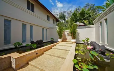 a house with a koi pond in the backyard at 30 - Panoramic View Villa in Thalang in Thalang