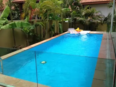 a large blue swimming pool in a backyard at 3 bedrooms Semi-Detached with Pool near Kamala Beach in Kamala Beach