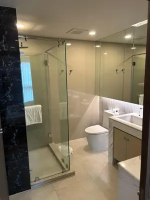 a bathroom with a shower and a toilet and a sink at Mida 1 in Phuket Town