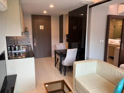 a living room and kitchen with a table and a couch at Mida 1 in Phuket Town