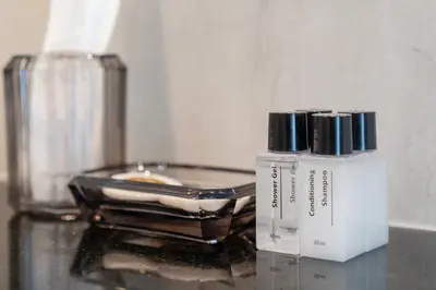 a bottle of cosmetics sitting on a glass table at Brand New Villa in Ravai for a wonderful holiday 3 - bedroom in Ban Saiyuan (1)