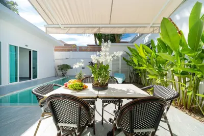 an outdoor dining room with a table and chairs at Brand New Villa in Ravai for a wonderful holiday 3 - bedroom in Ban Saiyuan (1)