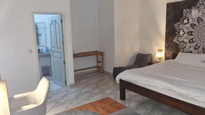 a bedroom with a bed and a desk and a chair at The Rai Resort Rawai - Pool & Garden in Ban Bang Chak
