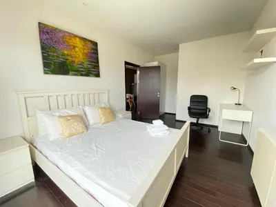 a white bed in a room with a desk at Pond View apartment Title Rawai by Clavis in Rawai Beach