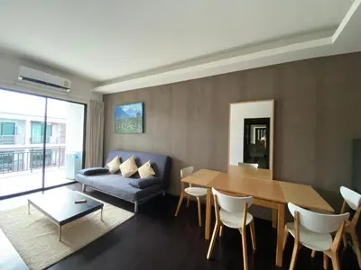 a living room with a table and a couch at Pond View apartment Title Rawai by Clavis in Rawai Beach
