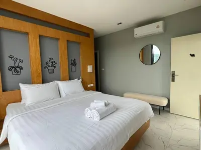 a bedroom with a large white bed with towels on it at Seaview 2 BR Spacious Modern Duplex near Kamala beach in Kamala Beach