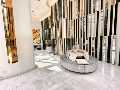 a lobby with a table and chairs in a building at the base updown\u4e00\u5367 in Phuket Town
