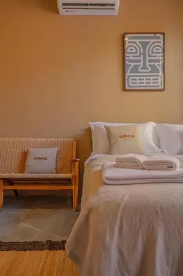 a bedroom with a bed and a bench next to it at The Wood Terrace in Ban Chin Tham Mai