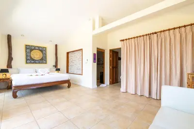a large bedroom with a bed and a couch at Tongtong Garden Holiday Hotel\u666e\u5409\u5c9b\u901a\u901a\u82b1\u56ed\u9152\u5e97 in Rawai Beach