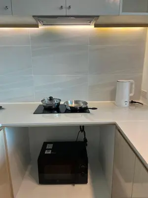 a kitchen with two pans on top of a stove at Beachfront Bliss at Naiyang Phuket by ALPHATEL in Phuket
