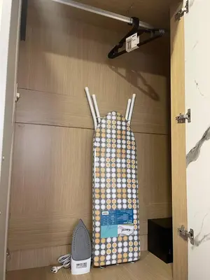 ajar door of a room with a rack with a backpack at Sunset Room Phuket in Ban Mai Salae