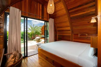 a bedroom with a bed and a large window at Tropical Chalet-Style 2BR Villa with Pool Pasak Paradise 2, Bangtao in Bang Tao Beach